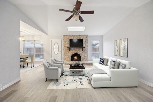 living area with plenty of natural light, wood finished floors, and vaulted ceiling