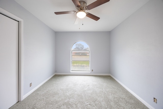 unfurnished room with carpet, baseboards, and a ceiling fan