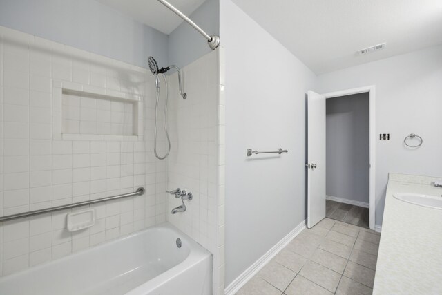 bathroom with visible vents, baseboards, tile patterned flooring, vanity, and shower / washtub combination