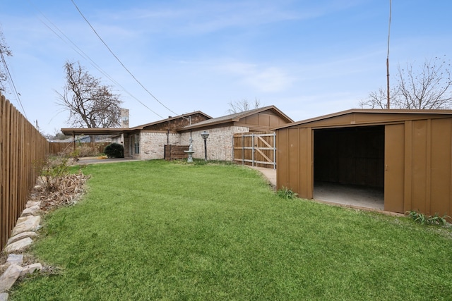 view of yard with an outbuilding and fence