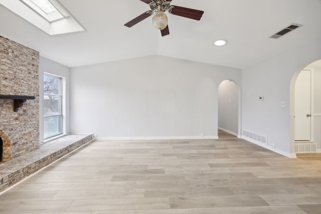 unfurnished living room featuring lofted ceiling, visible vents, and light wood-style flooring