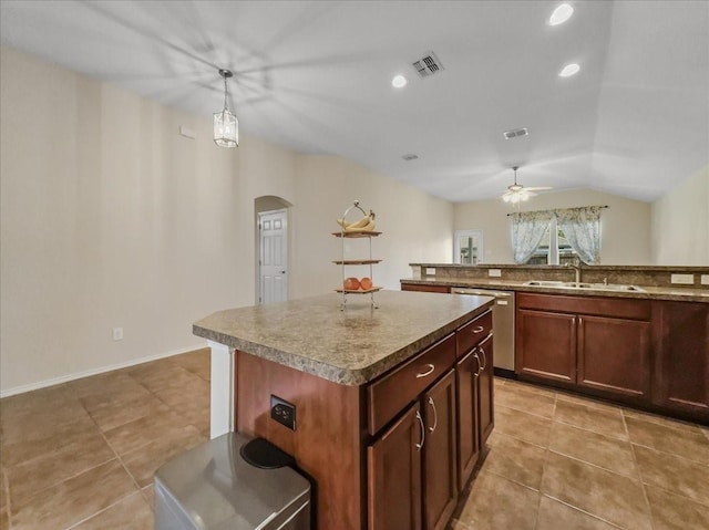 kitchen with vaulted ceiling, sink, pendant lighting, a kitchen island, and stainless steel dishwasher