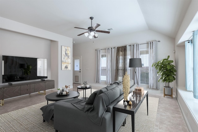 living area with lofted ceiling, visible vents, and ceiling fan