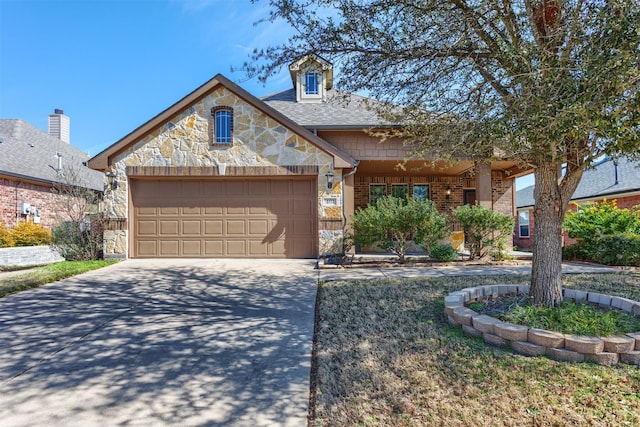 view of front of house with an attached garage, brick siding, driveway, stone siding, and roof with shingles