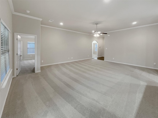 carpeted spare room featuring ceiling fan and ornamental molding