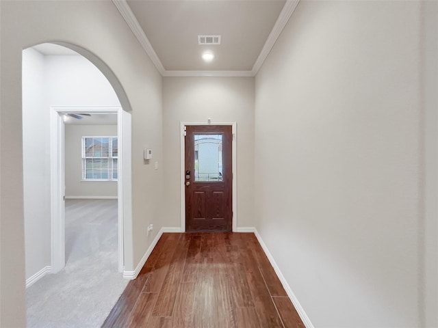 entryway featuring hardwood / wood-style flooring and ornamental molding