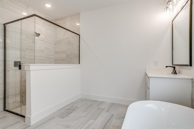 bathroom with vanity and shower with separate bathtub