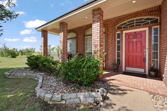 view of exterior entry featuring covered porch