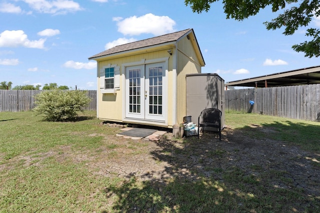 rear view of property with a yard and an outdoor structure