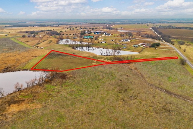 aerial view with a rural view and a water view