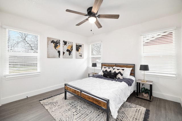 bedroom with ceiling fan, baseboards, and dark wood-type flooring