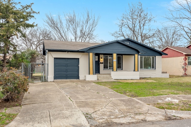 single story home with covered porch, a front yard, and a garage