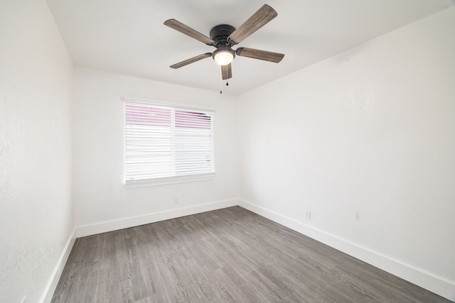 unfurnished room featuring ceiling fan, baseboards, and wood finished floors