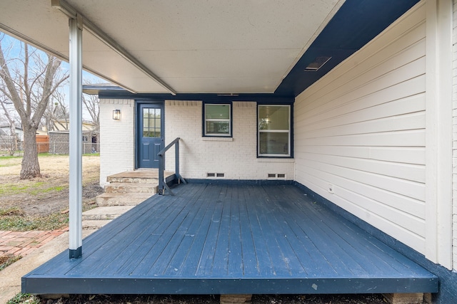 wooden terrace featuring visible vents