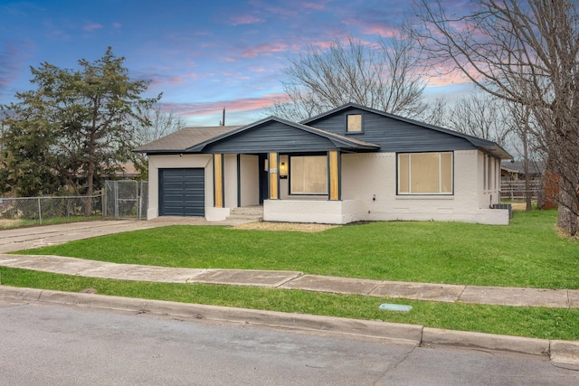 view of front of house featuring a garage, a lawn, concrete driveway, fence, and brick siding