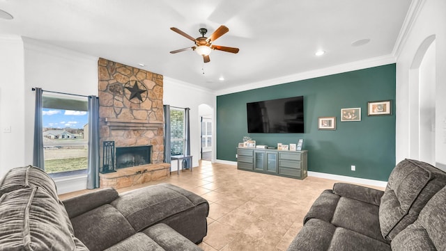 living area with arched walkways, ornamental molding, a fireplace, and light tile patterned floors