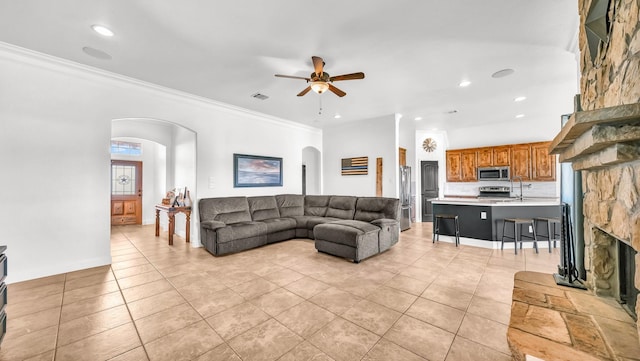157 Churchill Cir, Weatherford, TX 76085 - living area with arched walkways, a ceiling fan, light tile patterned floors, recessed lighting, and ornamental molding