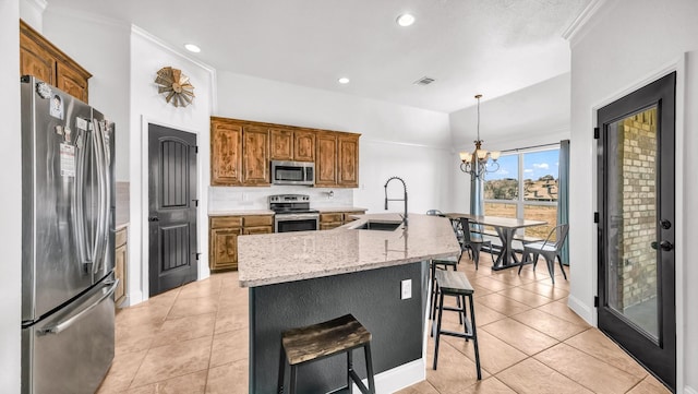 157 Churchill Cir, Weatherford, TX 76085 - kitchen with stainless steel appliances, brown cabinetry, a chandelier, recessed lighting, and a breakfast bar