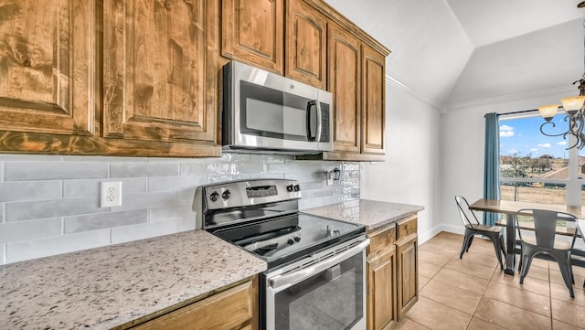 157 Churchill Cir, Weatherford, TX 76085 - kitchen featuring stainless steel appliances, lofted ceiling, tasteful backsplash, light stone countertops, and light tile patterned floors