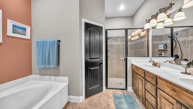 bathroom featuring double vanity, a garden tub, tile patterned flooring, a shower stall, and a sink