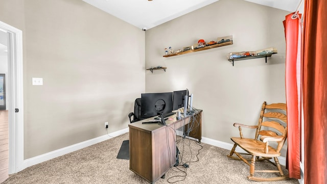 office area with light carpet, baseboards, and vaulted ceiling