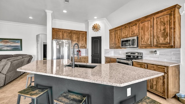 157 Churchill Cir, Weatherford, TX 76085 - kitchen with appliances with stainless steel finishes, ornamental molding, a breakfast bar area, tasteful backsplash, and open floor plan