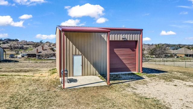 view of outbuilding with fence and an outdoor structure