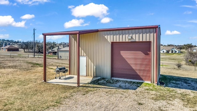 view of outbuilding with fence and an outbuilding