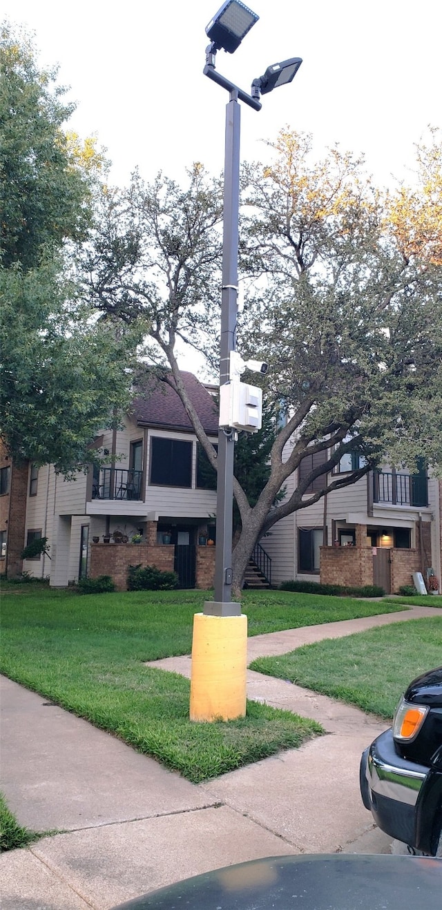 exterior space with a front yard and brick siding