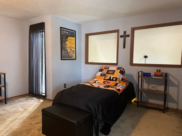 bedroom featuring light carpet, a textured ceiling, and baseboards