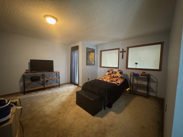 bedroom featuring carpet and a textured ceiling