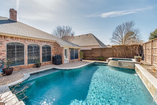 view of pool with an in ground hot tub