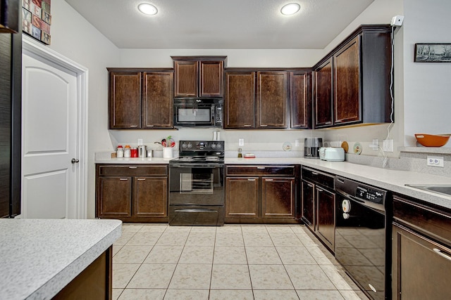 kitchen featuring black appliances, dark brown cabinets, light countertops, and light tile patterned flooring