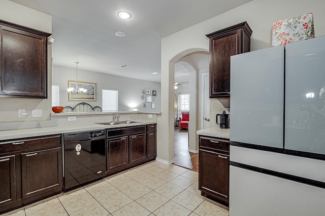 kitchen featuring dark brown cabinets, dishwasher, light countertops, and a sink