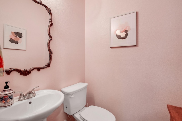 bathroom featuring toilet and a sink