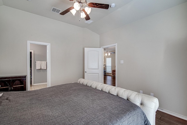 bedroom with a ceiling fan, lofted ceiling, baseboards, and visible vents