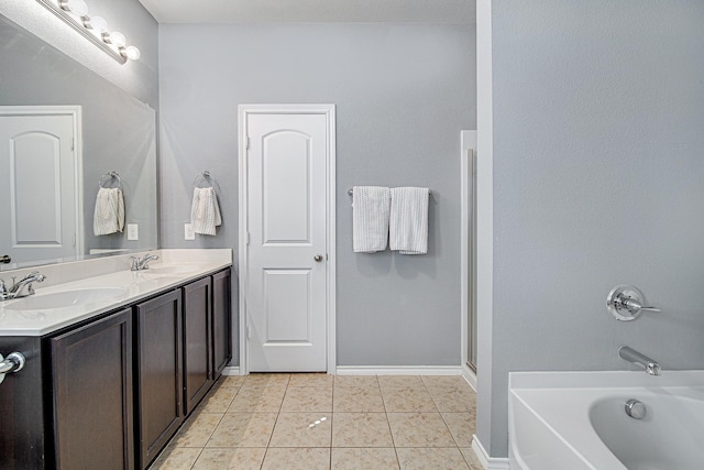 full bathroom featuring tile patterned floors, a washtub, double vanity, and a sink