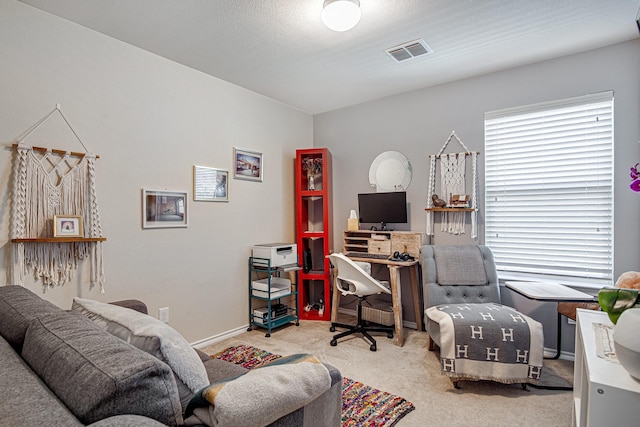 office area featuring visible vents, carpet flooring, and baseboards