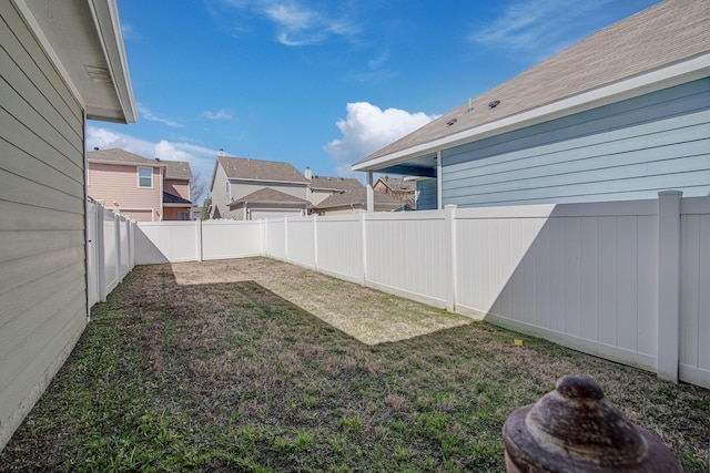 view of yard with a residential view and a fenced backyard