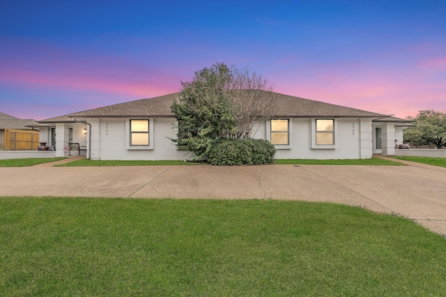 ranch-style home featuring a lawn