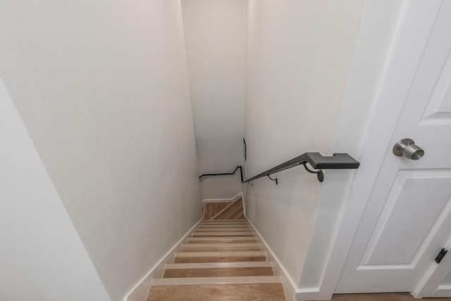 stairs with hardwood / wood-style floors