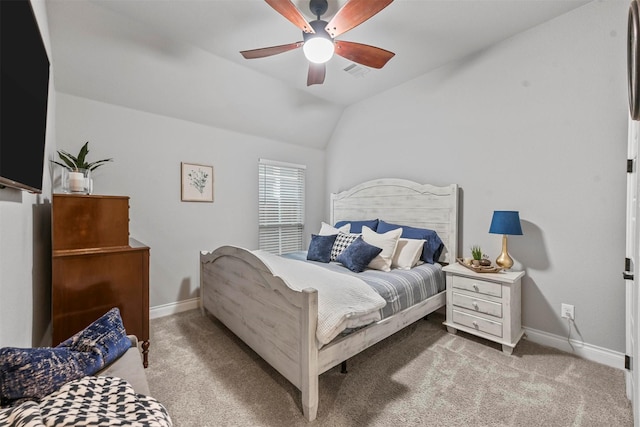 bedroom with lofted ceiling, light colored carpet, visible vents, and baseboards