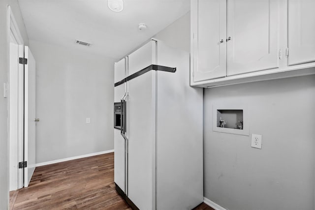 kitchen featuring visible vents, white cabinetry, dark wood finished floors, and baseboards