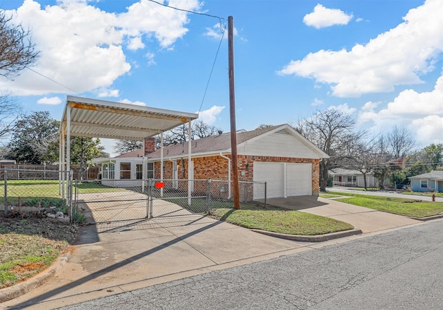 view of community featuring a fenced front yard, concrete driveway, an attached garage, and a gate