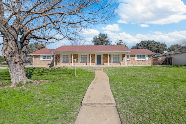 single story home with brick siding, a porch, and a front yard