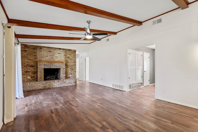 unfurnished living room with beamed ceiling, dark wood-style flooring, a fireplace, and visible vents