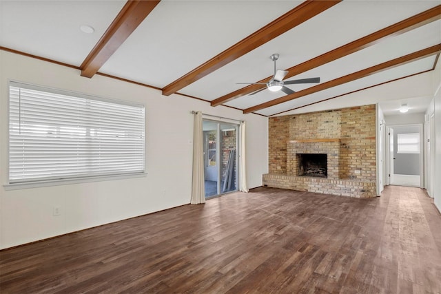 unfurnished living room with vaulted ceiling with beams, a brick fireplace, ceiling fan, and dark wood-style flooring