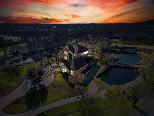 aerial view at dusk with a water view