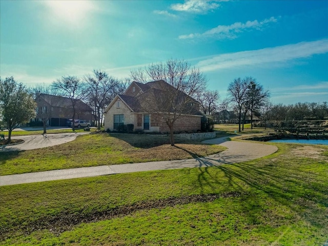 exterior space featuring a water view and a lawn