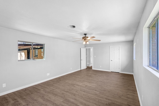 spare room featuring ceiling fan and dark hardwood / wood-style flooring